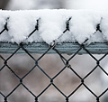 [Snow-topped fence] - snow, wet snow, chain link fence, bokeh